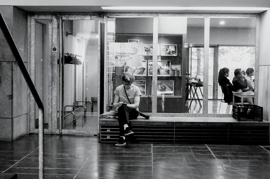 Behind the scenes of a television news studio with camera crew and presenter set
