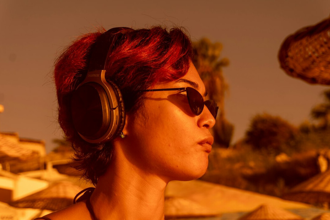 Studio portrait of a woman with short brown hair wearing a headset